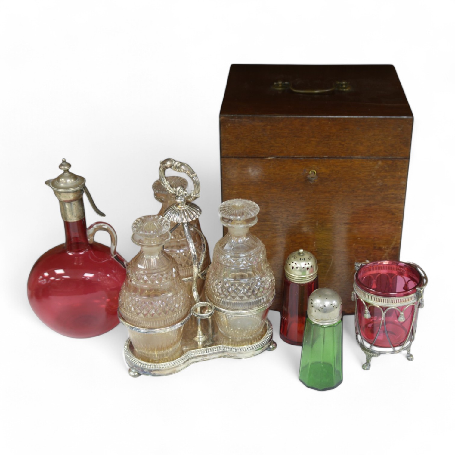 A cased silver plated three bottle liqueur stand, a cranberry decanter, sugar shaker and jam stand together with a green glass shaker, stand 27cm high (5). Condition - all items in good condition, box in need of a clean